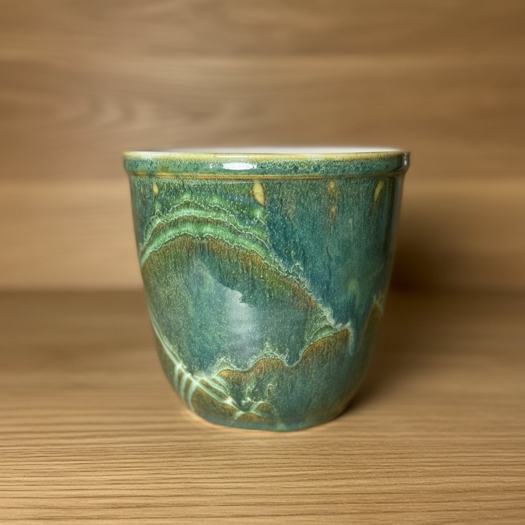 This flowing green glaze is on a pot that can hold utensils or an orchid