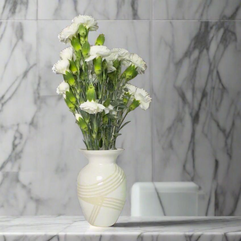 
                      
                        Medium white gloss vase with clear lines. with white flowers as decoration
                      
                    