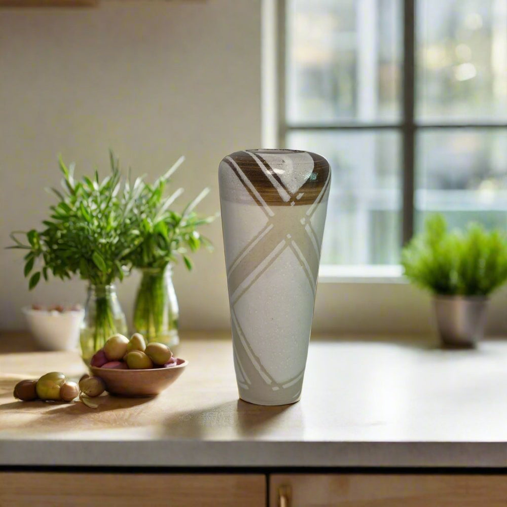 
                      
                        Tall white urn with dark brown, white and clear lines
                      
                    