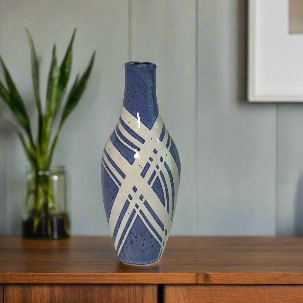 
                      
                        Vase with blue glossy glaze and white lines crossed over the body
                      
                    