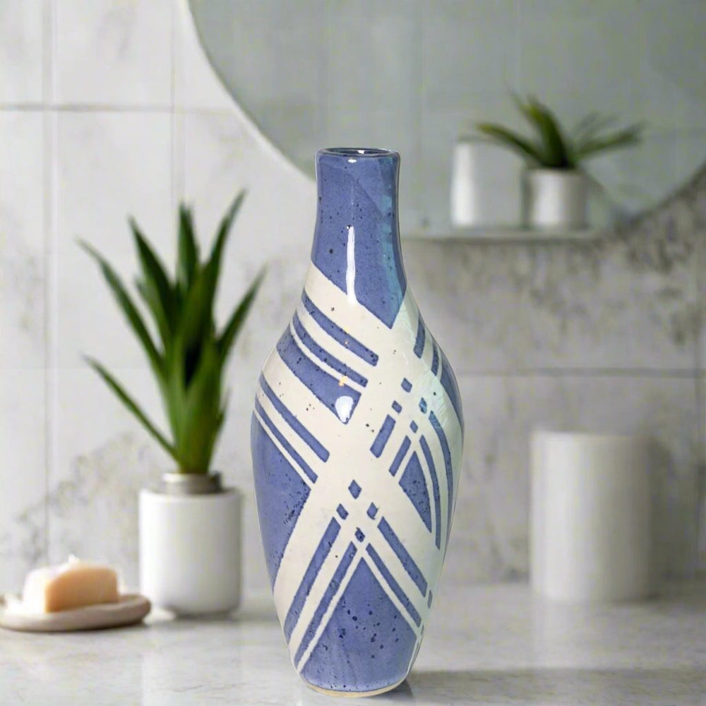 Vase with blue glossy glaze and white lines crossed over the body